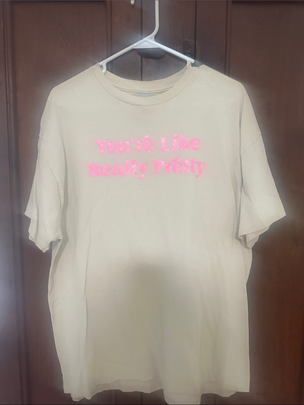 Gildan beige tee with bright pink graphic text